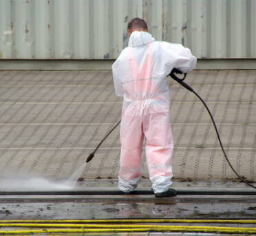 Male Using Restoration Cleaning Supplies For Industrial